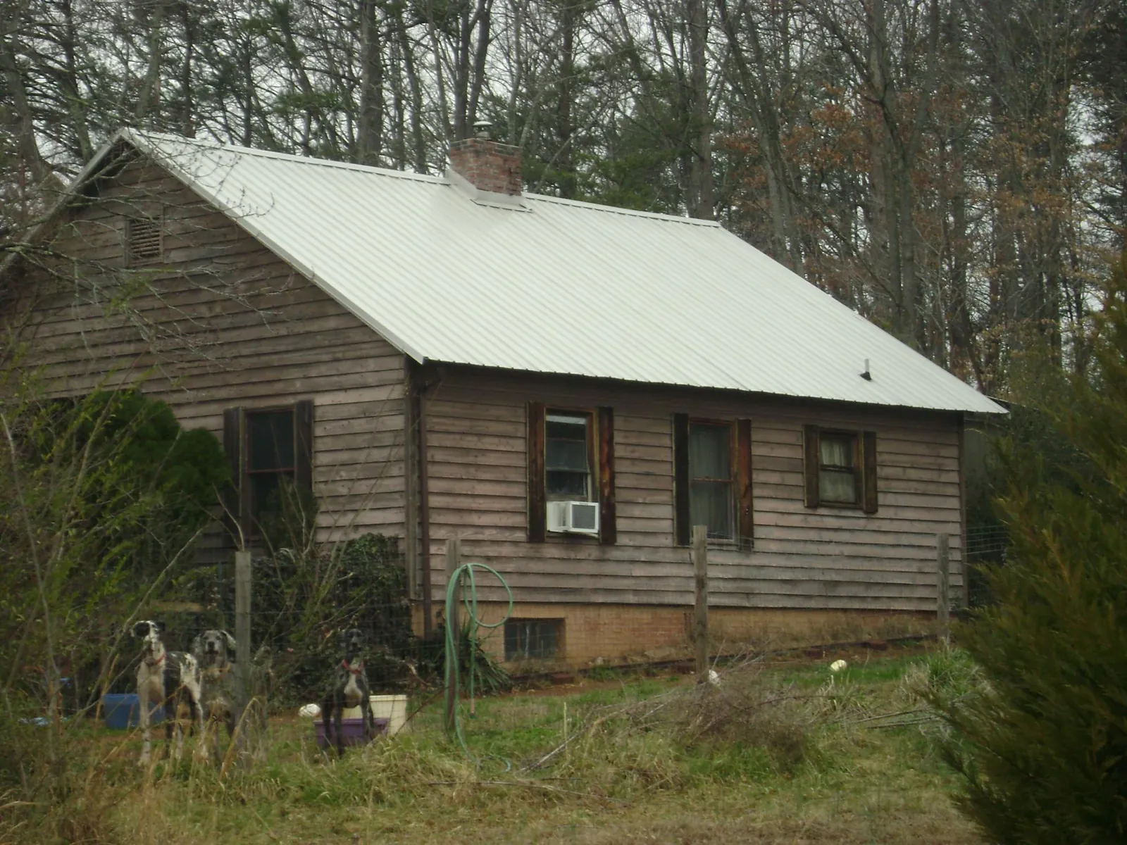 White metal roof on an old wood sided farmhouse, from a Metal Roof Installation job in Betterton